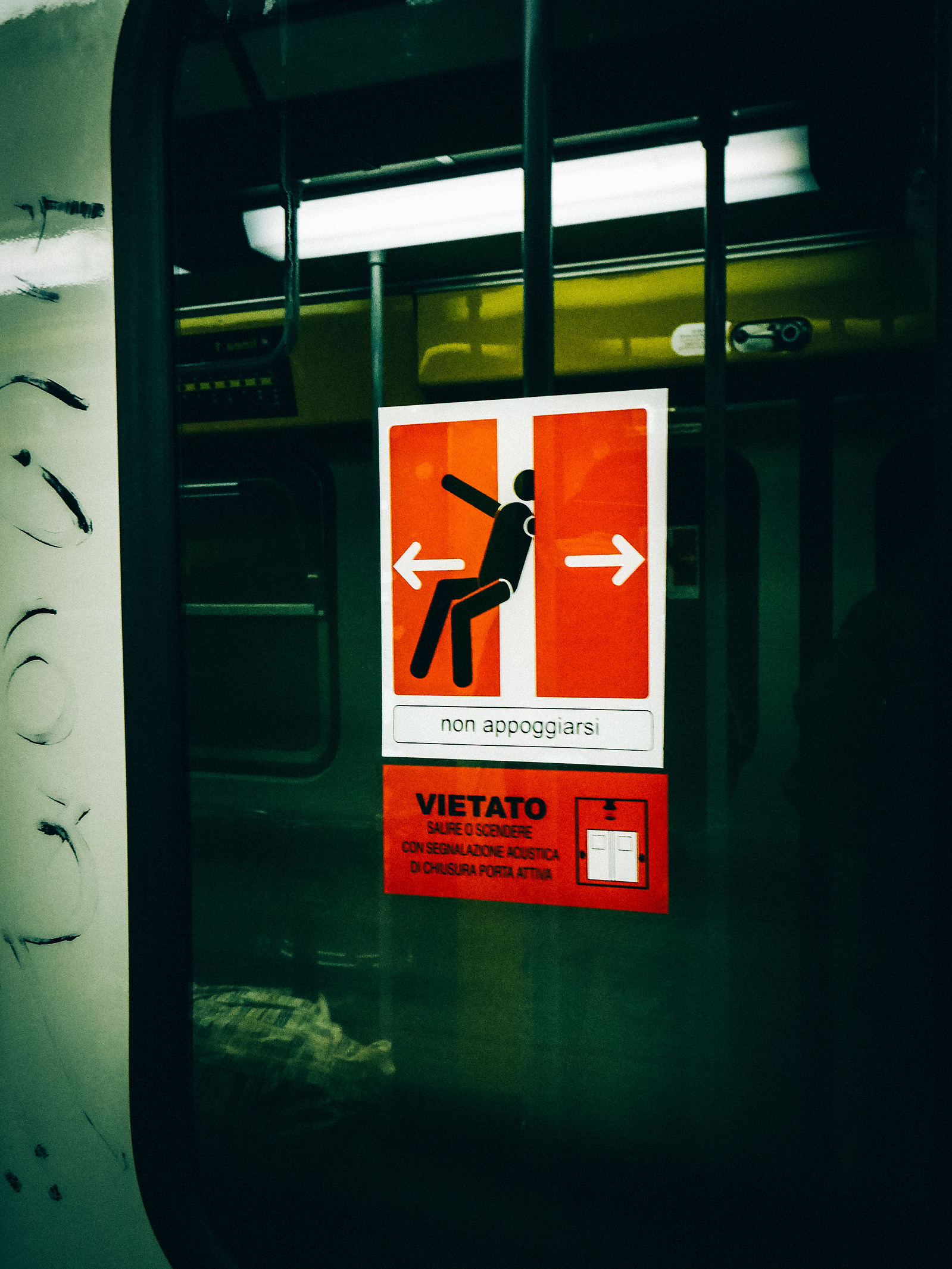 Un sticker qui indique de faire attention à la fermeture des portes dans la métro de Naples.