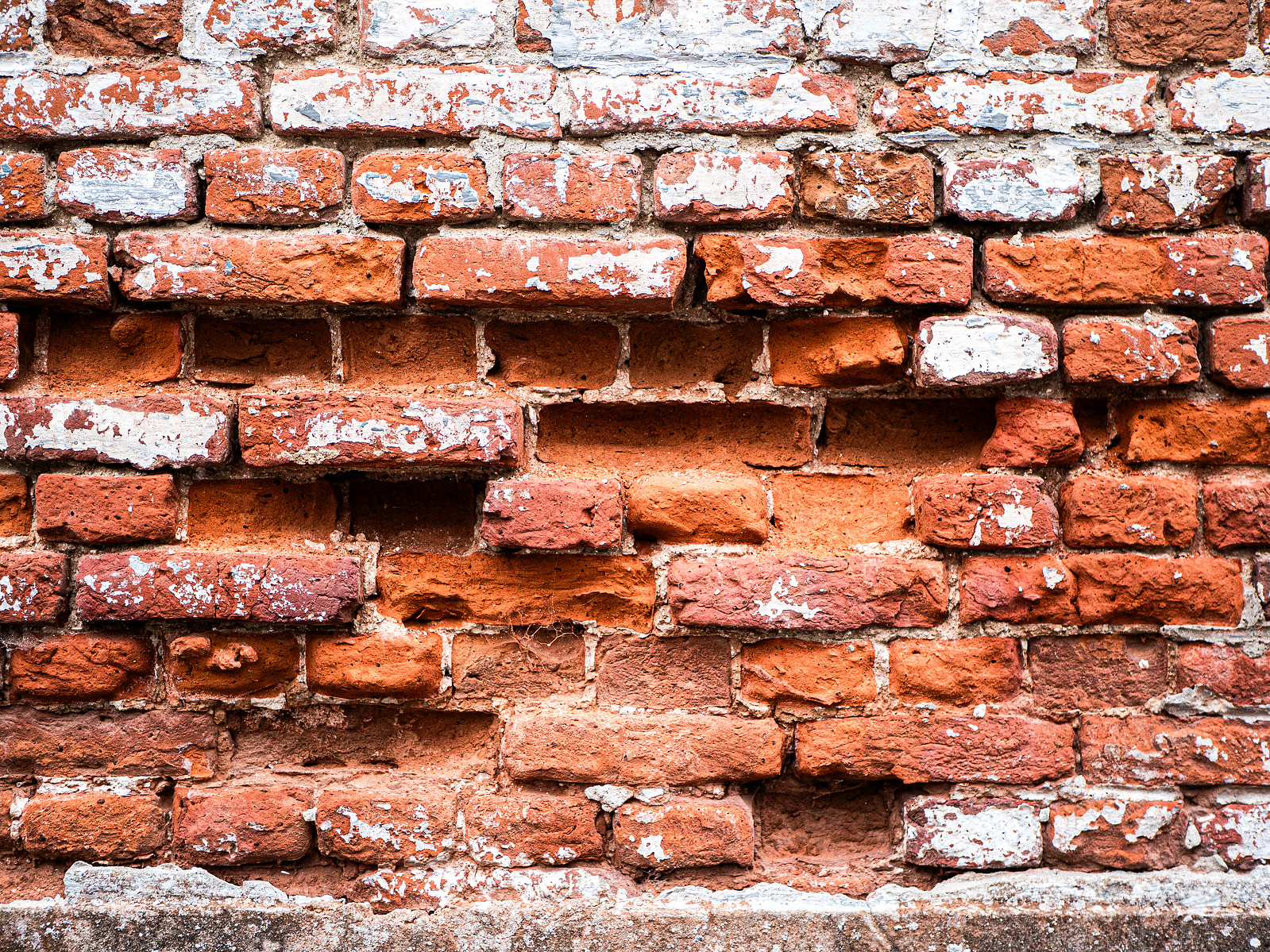 Un mur de brique très usé. Celles en Belgique.