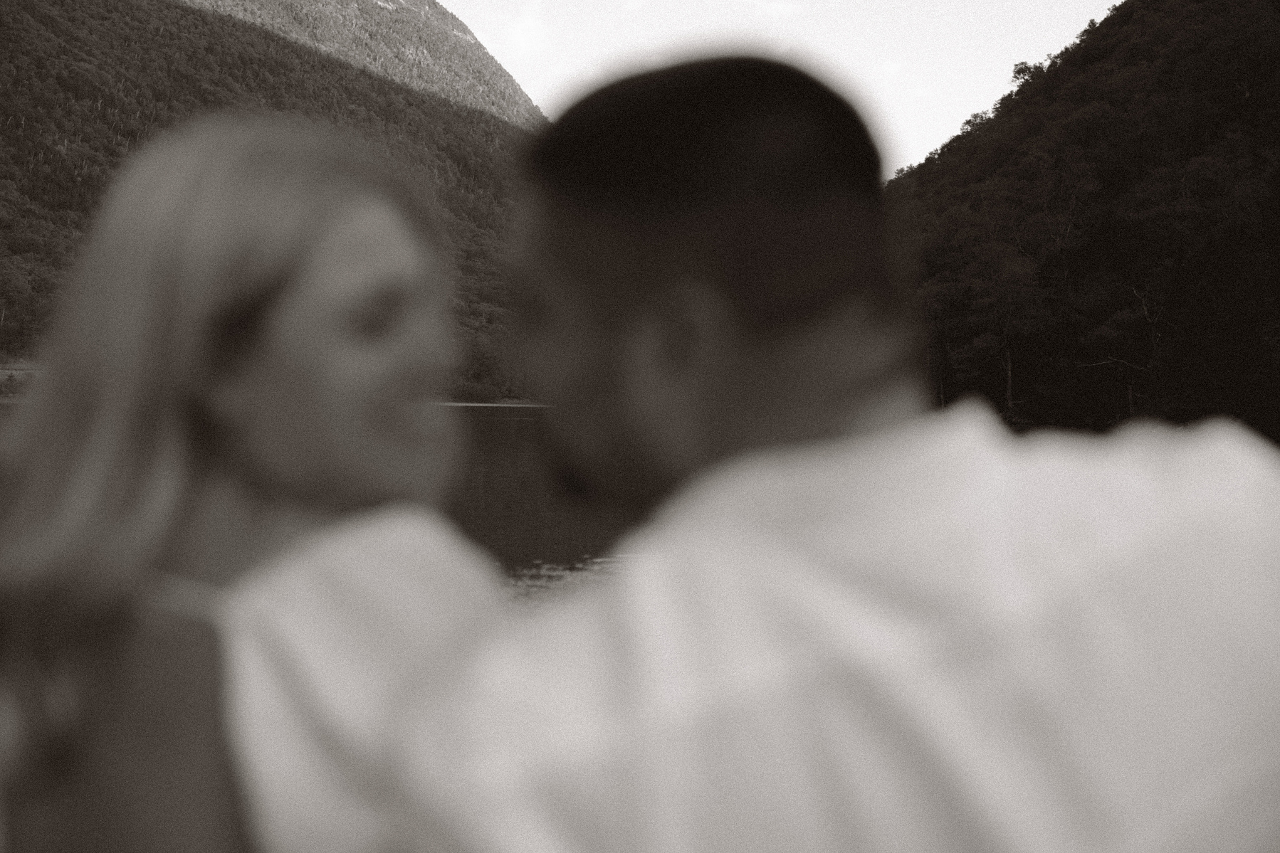 Blurry photo of bride and groom going in for a kiss. 