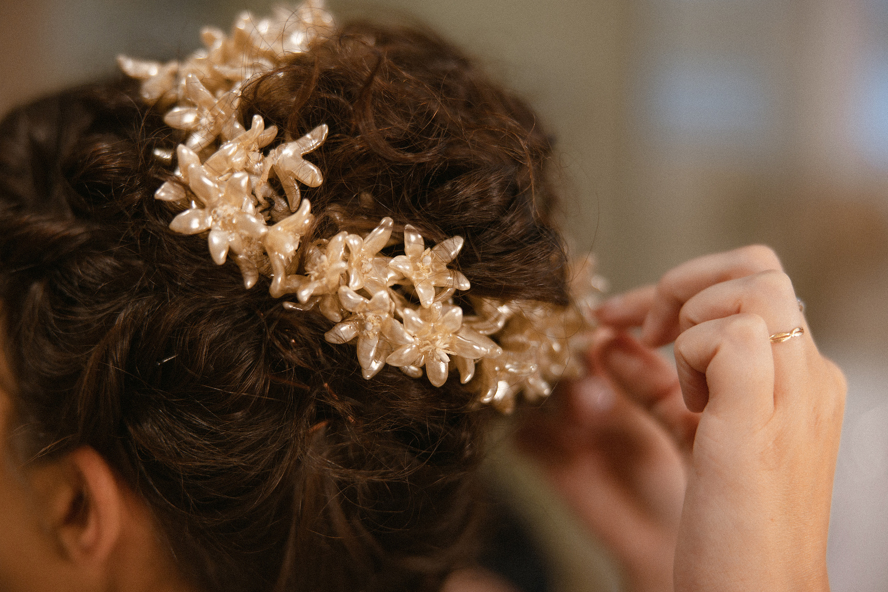 Bridesmaid fixing brides crown. 