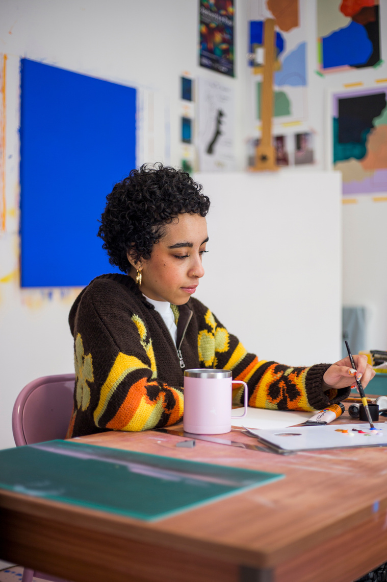 Millie Toyin Olateju sat painting in her studio 