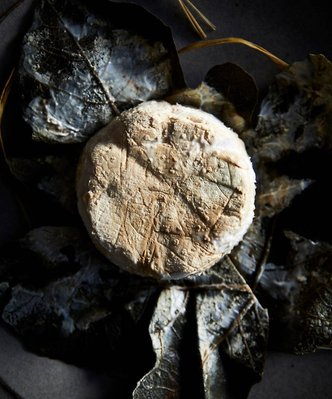 Food photography by Nic Gossage photographs soft cheese wrapped in vine leaf in Tasmania