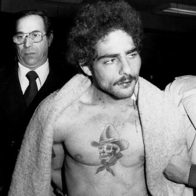 Picture from the NY Daily News 1980. Crazy Sal Desarno being arrested after Killing a cop. the photo features his prominant chest tatto, a cowboy skull tattooed by Tony Polito
