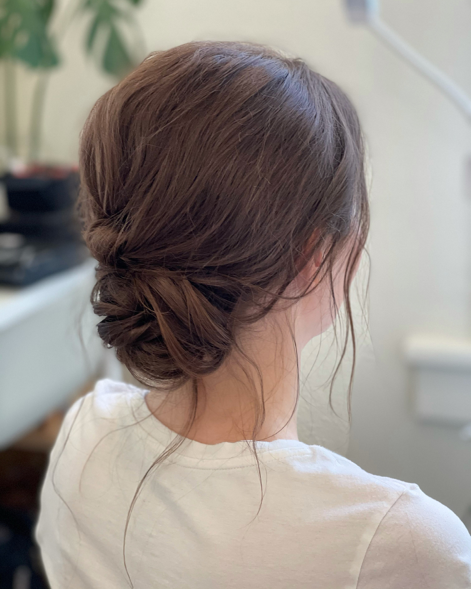 face-framing tendril, soft low hair chignon, low hair chignon