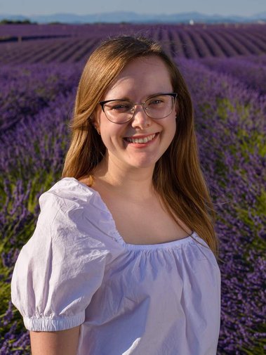 Sara stands in a field of lavender in Valensole, France.