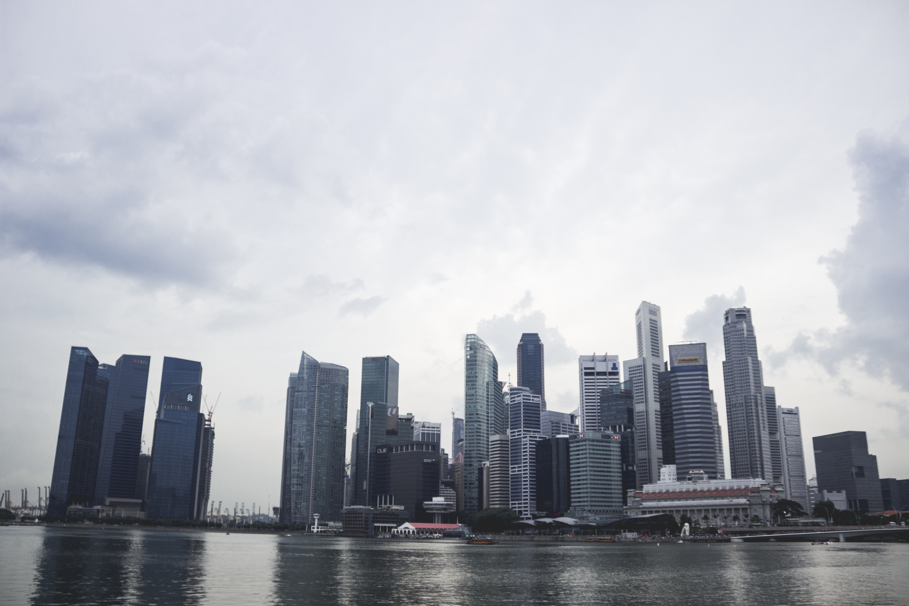 City skyline view with sky behind and lake in front