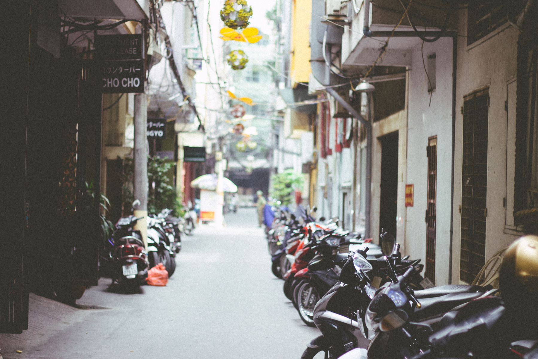 Alleyway of motorbikes and street lanterns