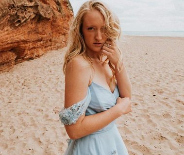 Bohemian bride wears ethereal pale blue off shoulder tulle wedding dress on Devon beach