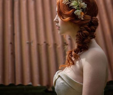 Closeup of bride wearing a metallic bridal jumpsuit and flower crown