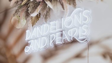 Trendy neon sign with dried flower display at Dandelions and pearls bridal boutique in Devon