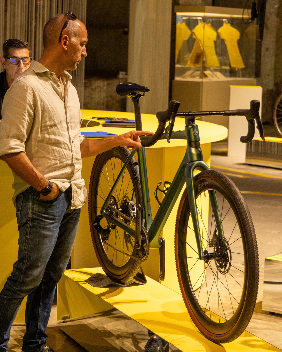A man looking at a Colnago bicycle.