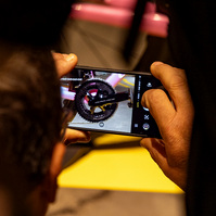 A man takes a photograph of Shimano Dura Ace gears