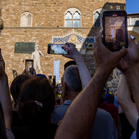 Crowds with mobile phones watching the Grand Depart, Tour de France in Florence.