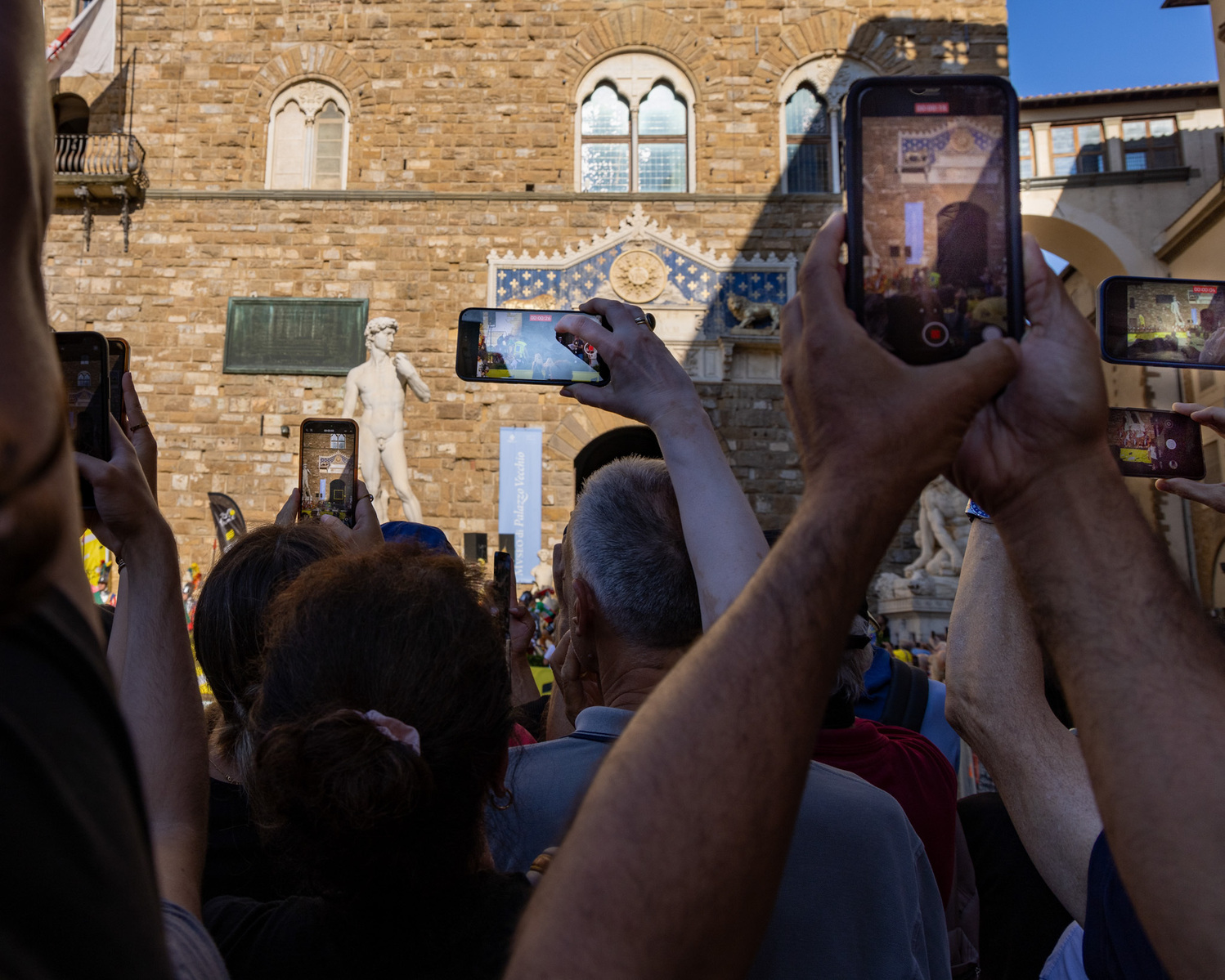 Crowds with mobile phones watching the Grand Depart, Tour de France in Florence.