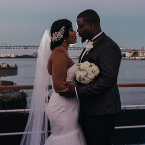Tenayah and Theodore share a private moment on the Spirit of Philadelphia at sunset in this backlit night shot. 