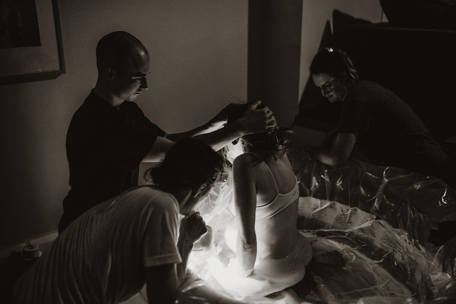 Woman birthing baby in to water