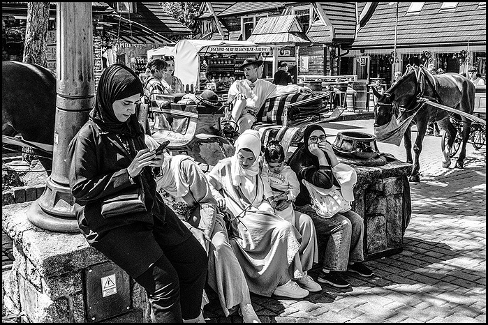 Muslim women with a Polish goral man with horses