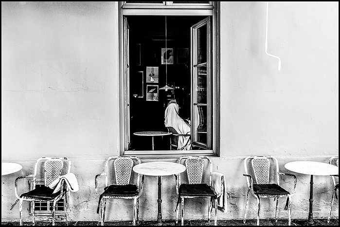 a Muslim woman in a window of a cafe