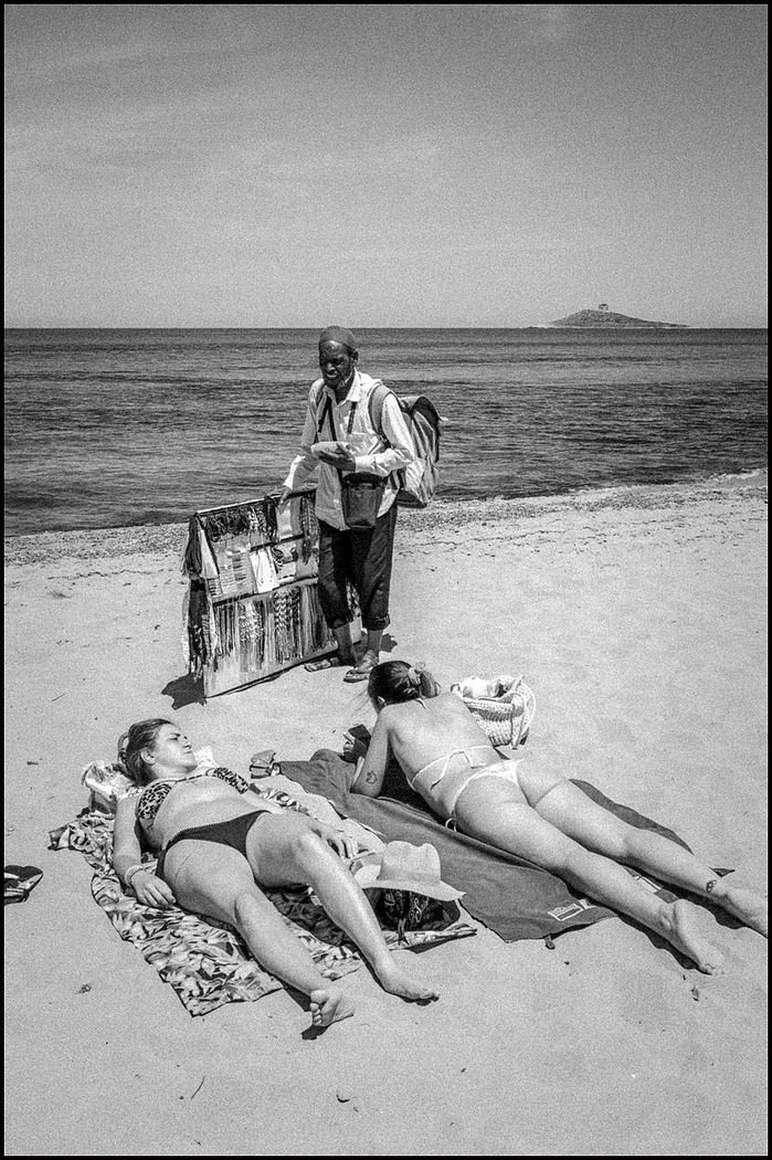 A refugee seller on the beach in Sicily