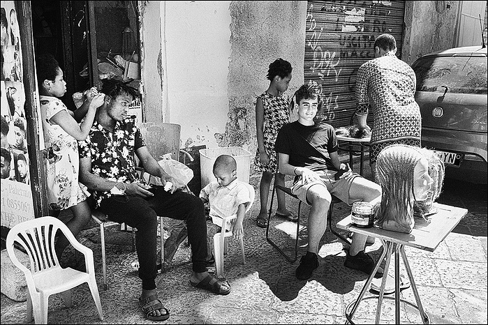 African refugee street hairdresser in Palermo