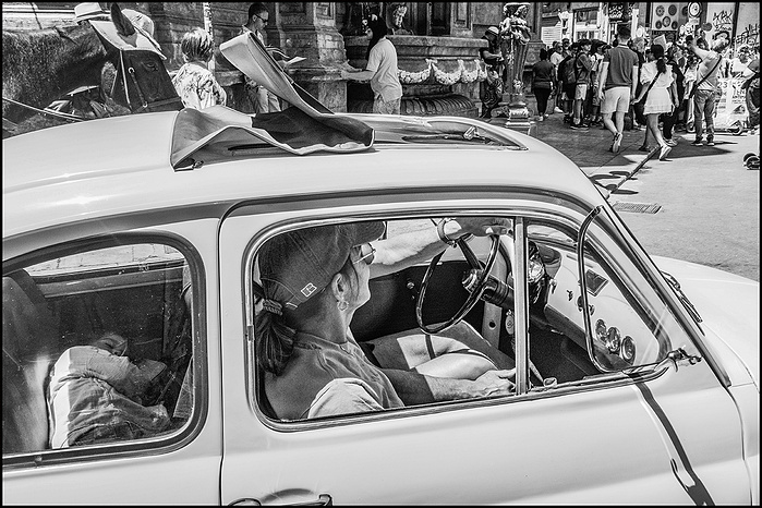 A child sleeping at the back seat of Italian fiat.