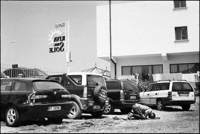 A Muslim praying in a car park in Sicily