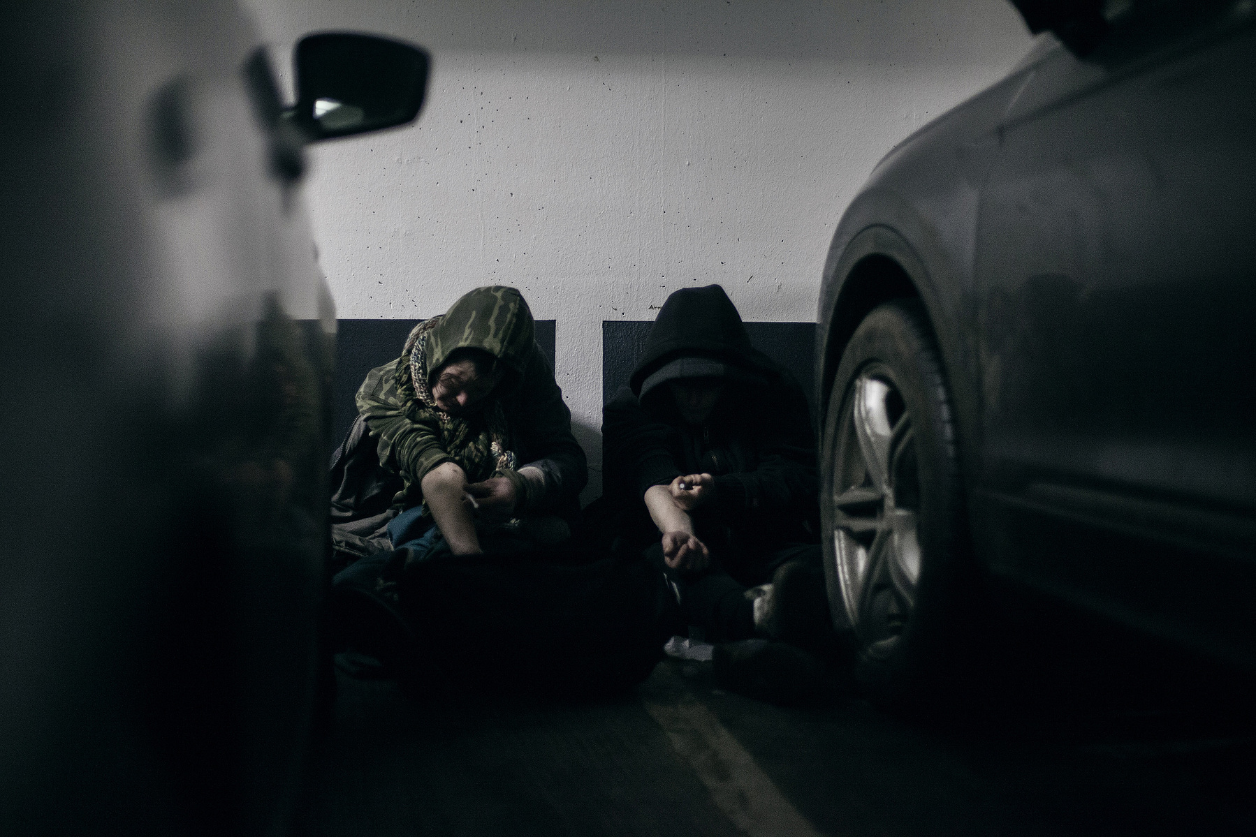 They often sleep in the underground carparks. The further down, the warmer it is.