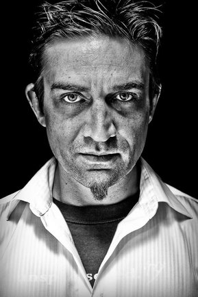 Gritty black and white portrait photo of a man from the series Exteriors by Kelly Castro