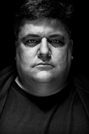 Gritty black and white portrait photo of a man from the series Exteriors by Kelly Castro