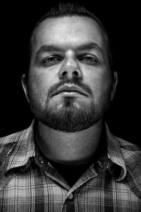 Gritty black and white portrait photo of a man from the series Exteriors by Kelly Castro