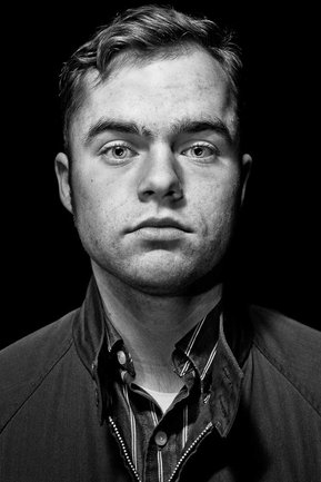 Gritty black and white portrait photo of a young man from the series Exteriors by Kelly Castro