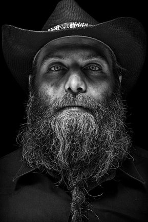 Gritty black and white portrait photo of a bearded man from the series Exteriors by Kelly Castro
