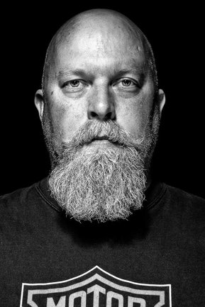 Gritty black and white portrait photo of a man from the series Exteriors by Kelly Castro