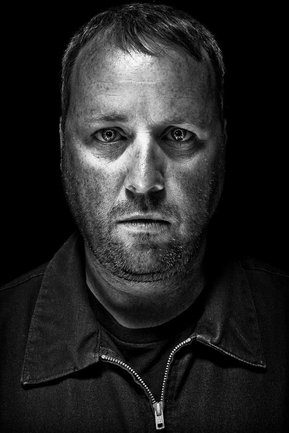 Gritty black and white portrait photo of a man from the series Exteriors by Kelly Castro