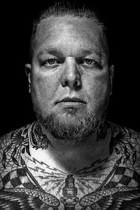 Gritty black and white portrait photo of tattoo artist Klem from the series Exteriors by Kelly Castro