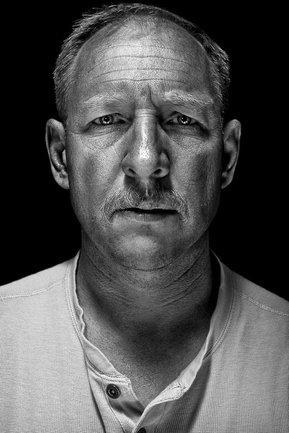 Gritty black and white portrait photo of a man from the series Exteriors by Kelly Castro
