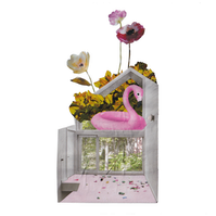 Analog collage of an interior of a house with a pink flamingo floatie in the second floor window and three stems of flowers coming out from the top.