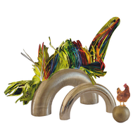 Analog collage of a feathery dinosaur perching above a gold metallic arch with a chicken standing on the end.