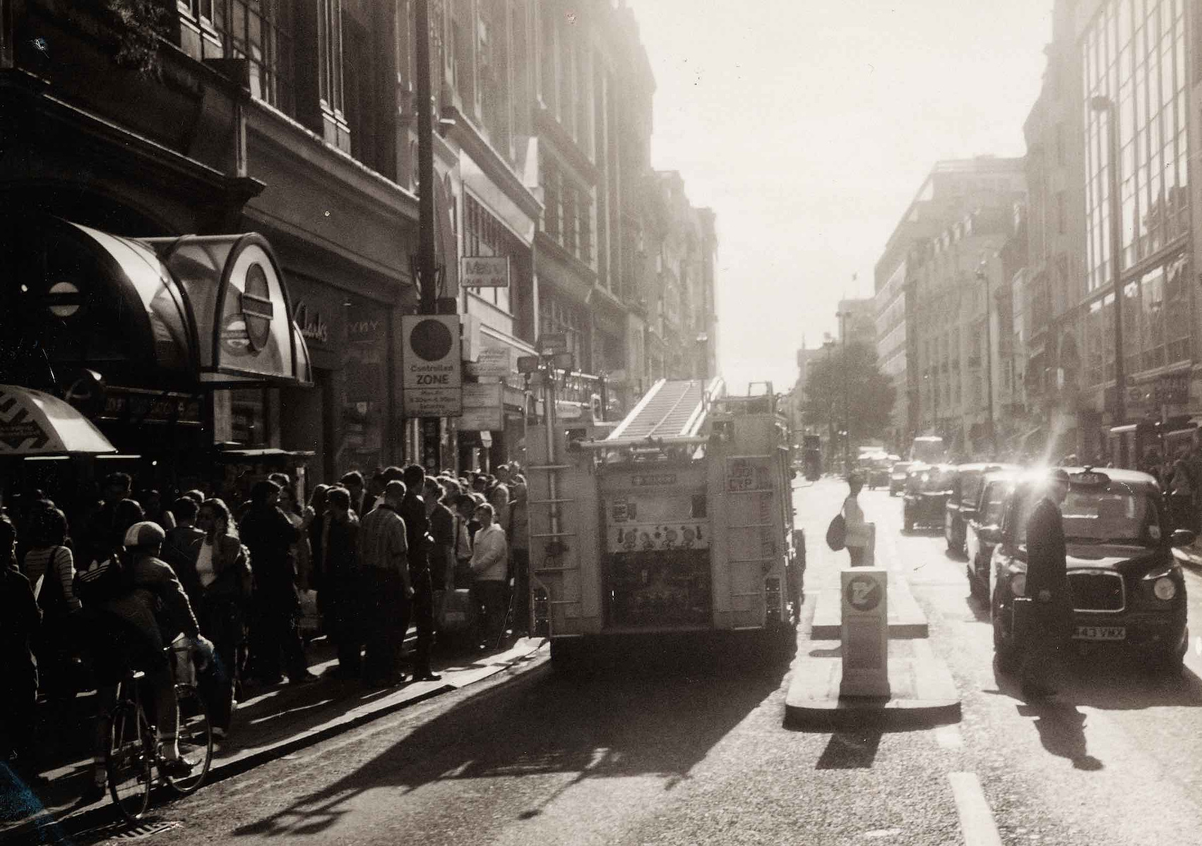 A Black and white looking down Oxford street outside Tottenham Court Road Station in August 2001.