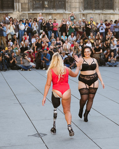 Relai entre deux jeunes femmes dont l&amp;#x27;une avec une prothèse de jambe lors du défilé The All Sizes Catwalk à Paris en septembre 2019