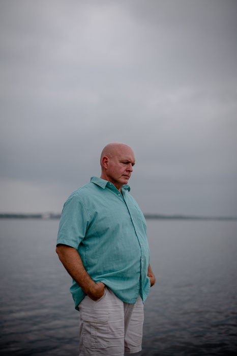BELLPORT, NEW YORK- JULY 12, 2021: Tom Wilson, 52, poses for a portrait at the Bellport Marina on Monday. Wilson was an NYPD officer at the 90th Precinct which typically covers the Williamsburg and Bushwick neighborhoods in Brooklyn. On 911 Wilson was tas