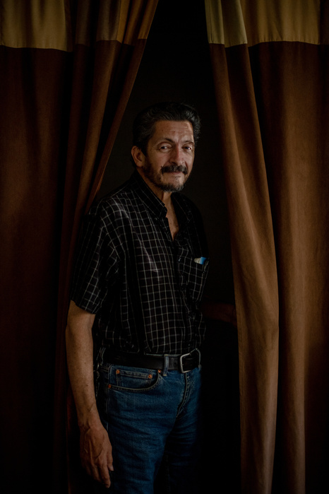 STATEN ISLAND, NEW YORK- AUGUST 13, 2021: Jose Santiago poses for a portrait in his living room. Santiago, 72, was the news director at WBAI Radio when 9/11 happened. He was on his way into his office on Wall Street when the second plane hit. As the direc