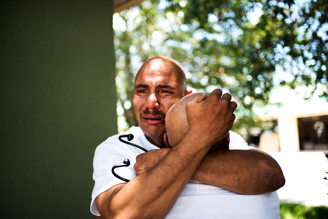 ORLANDO, FLORIDA- JUNE 16, 2016: Alberto Capo Junior cries and hugs his father, Alberto Capo, after seeing the casket of his nephew ,Luis Omar Ocasio-Capo after he was shot at the Pulse Nightclub massacre on Sunday morning. "I can't see him like that...