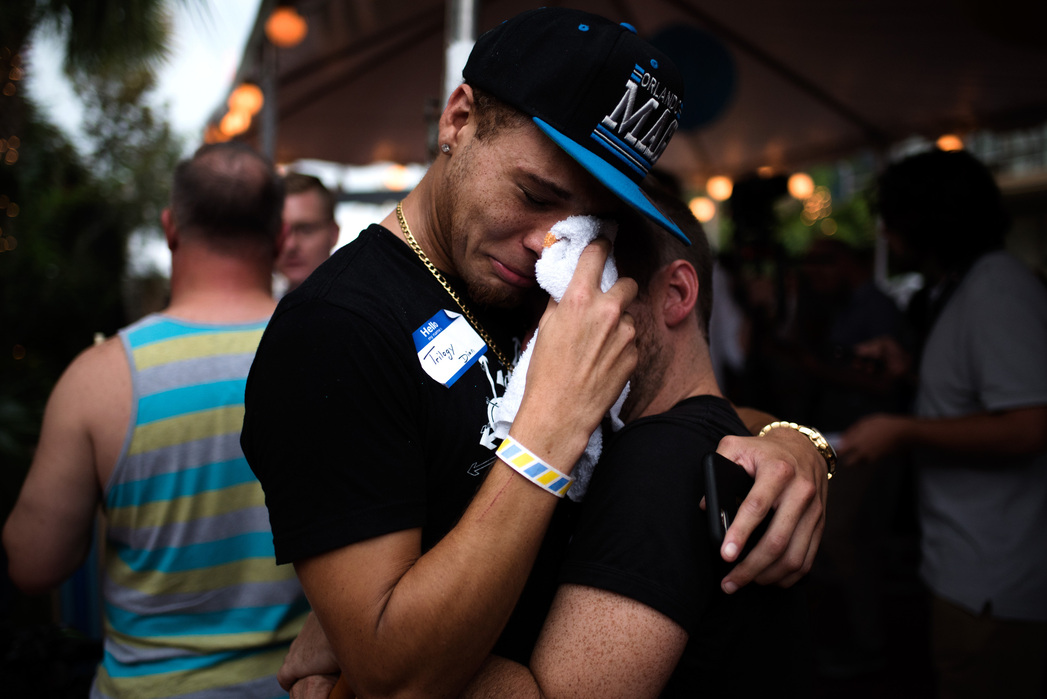ORLANDO, FLORIDA- JUNE 11, 2016: Trilogy Dion, left and Wes Miles embrace after exiting a gathering at Parliment House Resort in Orlando. **note, Trilogy did not give his name, I read it off of his name tag. He walked away too quickly and Wes wasn’t comfo