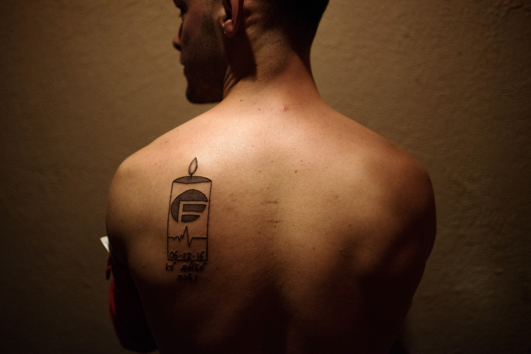 ORLANDO, FLORIDA- JUNE 17, 2016: Levi Sapir takes off his shirt to show his new tattoo on Friday night at Savoy Orlando. “I designed it myself… I wanted to make something orginal that was important to me.” Many locals talked about how small the crowds wer