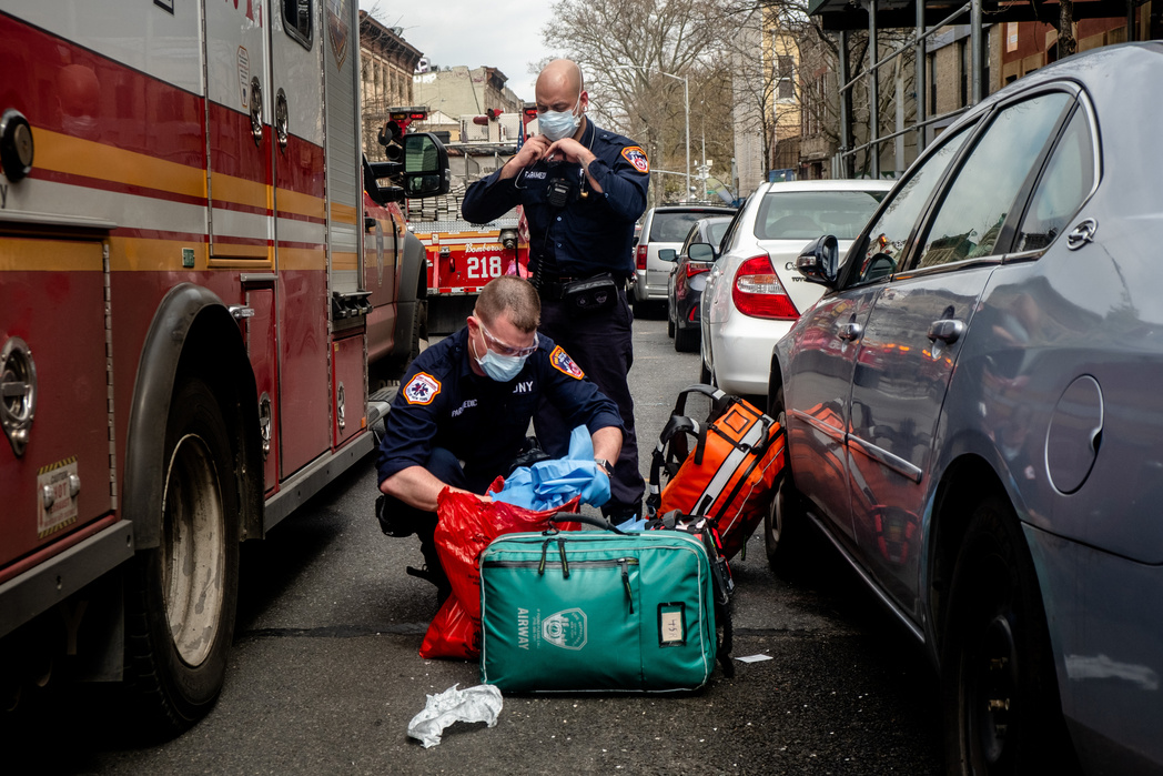 BROOKLYN, NEW YORK– APRIL 8, 2020: NYTVIRUS NYCVIRUS FDNY and FDNY EMT's respond to a call in Bushwick. A woman had CPR performed on her at her apartment. Two neighbors standing nearby said that EMTs had been called the day before for the same woman but t