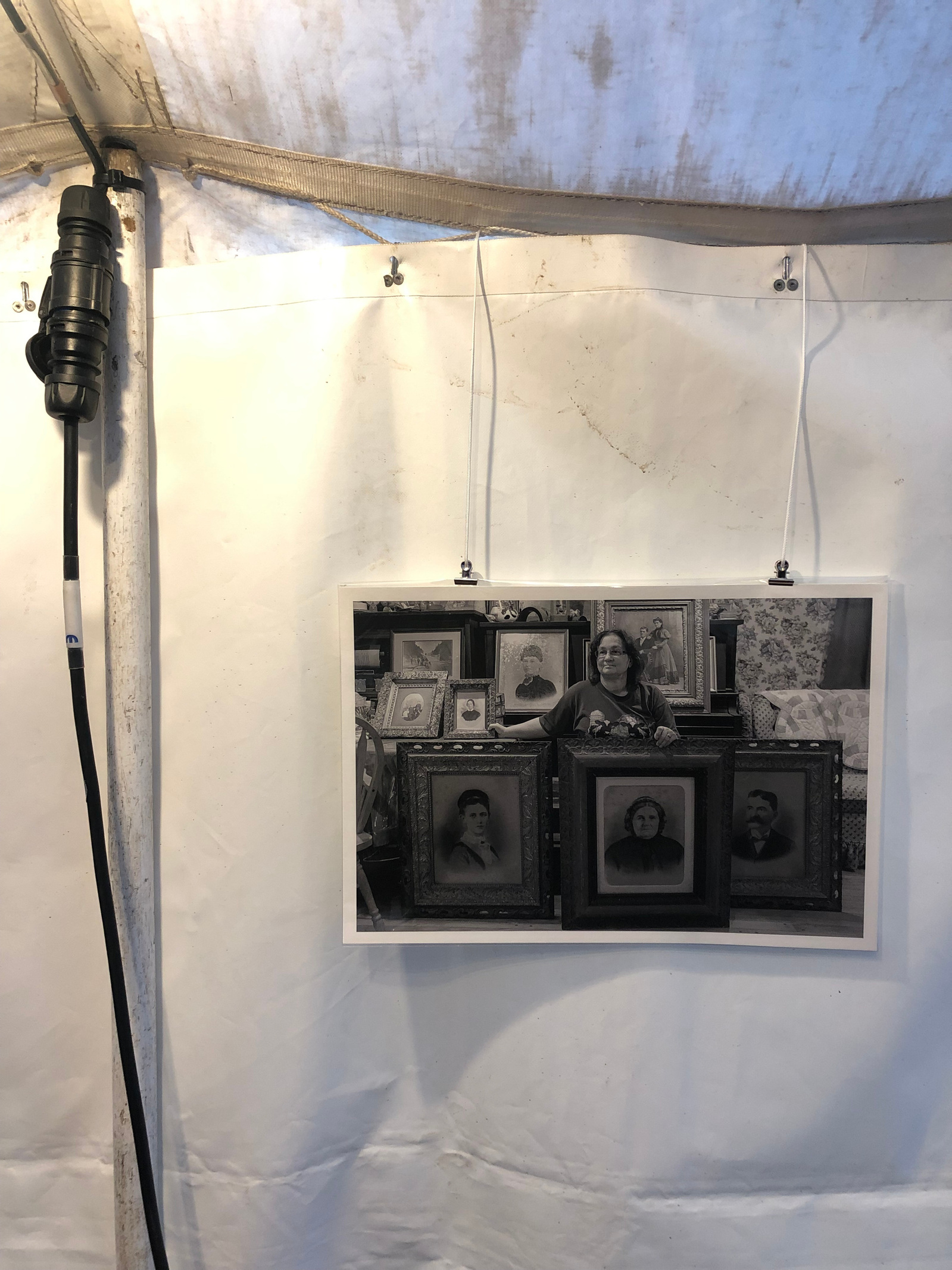 Black and white photo print hanging in a marquee