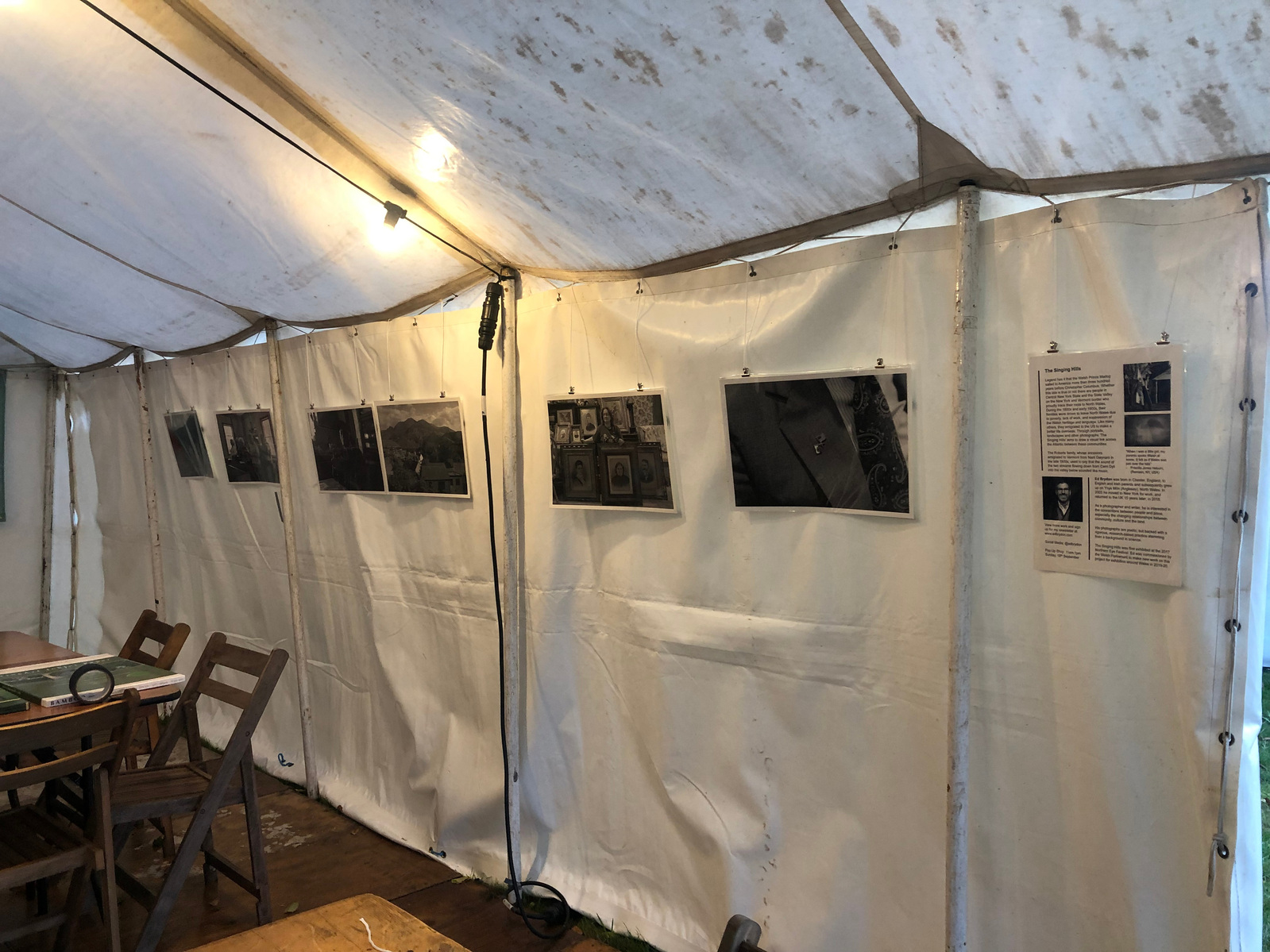 Photographic prints hanging in a marquee