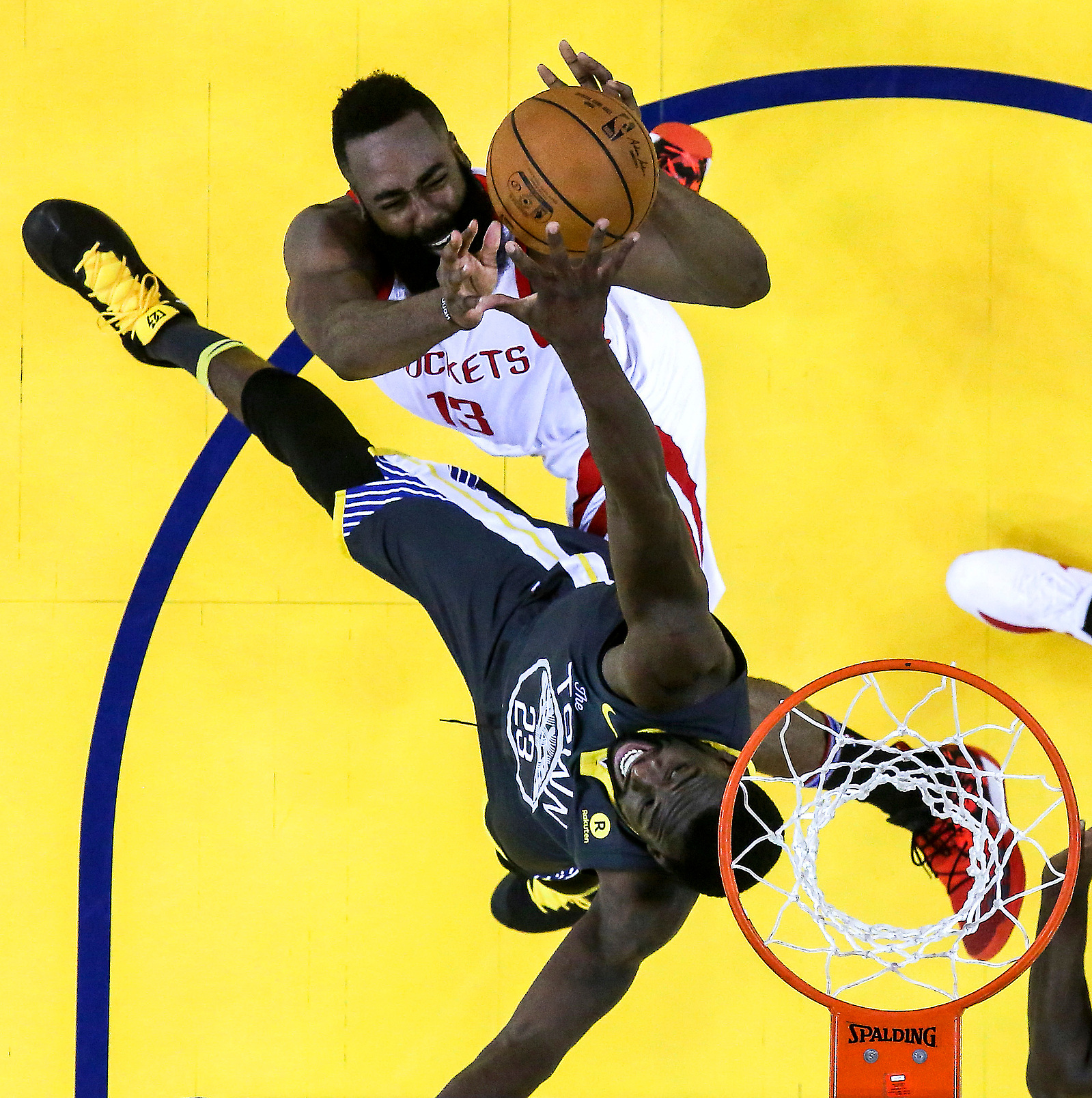 Houston Rockets guard James Harden (13) goes up for a shot on Golden State Warriors forward Draymond Green (23) during the second half of Game 4 of the Western Conference Finals at Oracle Arena Tuesday, May 22, 2018 in Oakland.