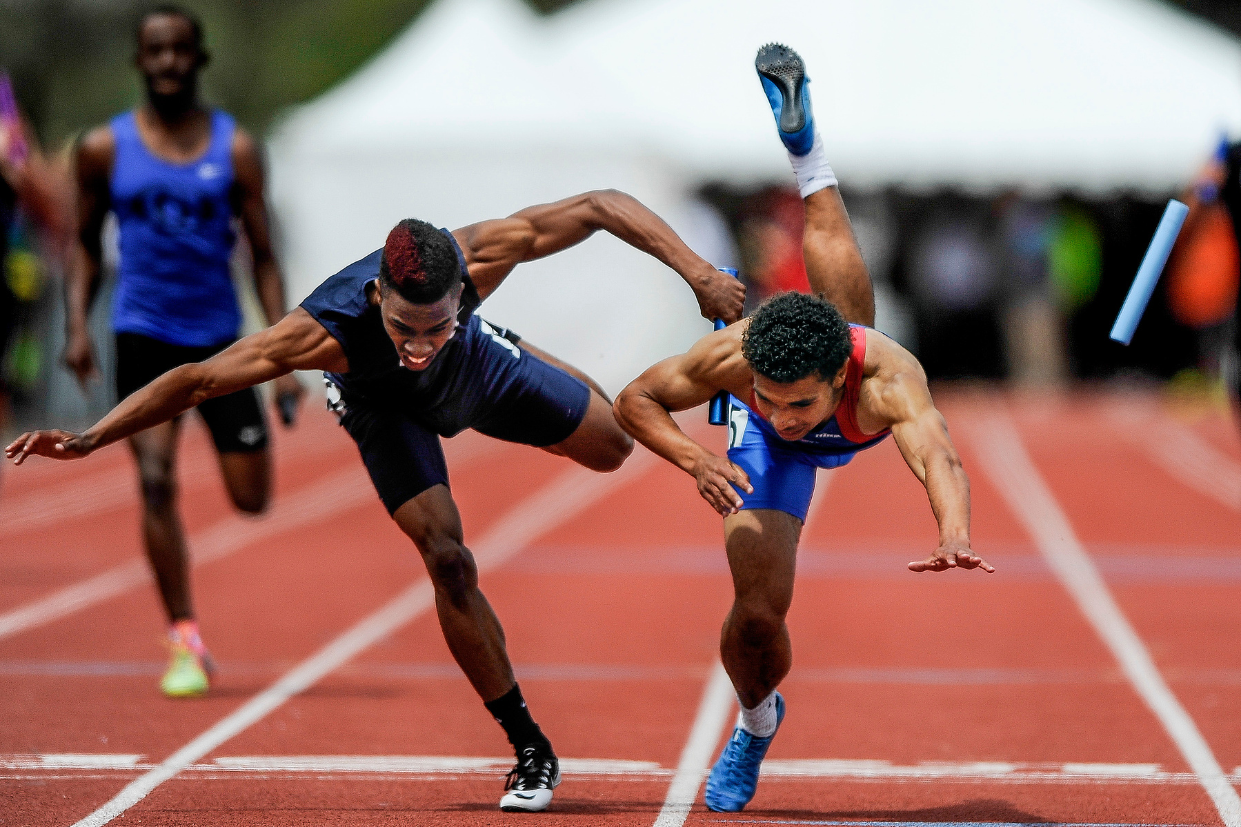 Fountain-Fort Carson's Jaysean Skrine, right, edges out Cherokee Trail's Brandon Singleton by .02 seconds to win the 5A 4x200 meter relay with a time of 1:26.21. Students from across the state competed in the second day of events at the Colorado Track and